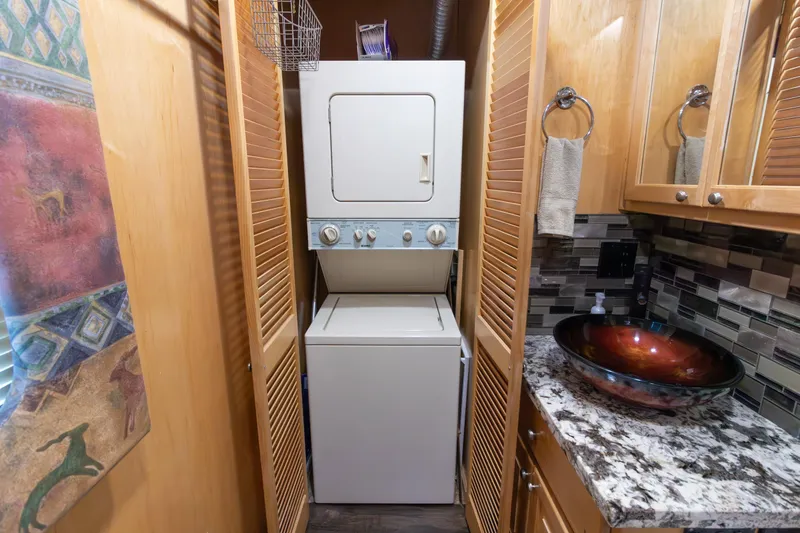 Slide: The Image of Laundry area in 2001 Stardust Cruisers Executive Aft Cabin with stacked washer-dryer and granite countertop. - 39