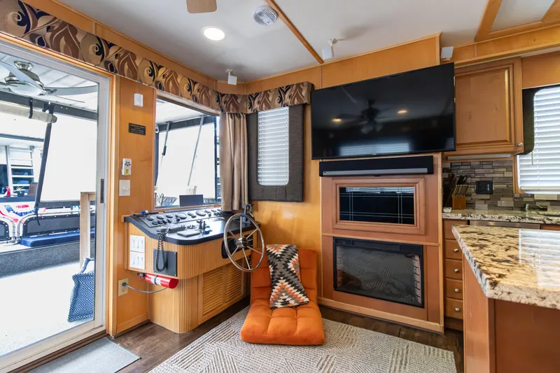 Slide: The Image of Interior of 2001 Stardust Cruisers Executive Aft Cabin with helm, TV, and fireplace. - 7