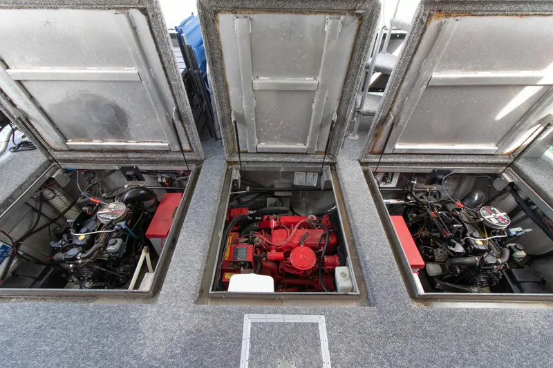 Slide: The Image of Engine compartment of 2001 Stardust Cruisers Executive Aft Cabin, showcasing three engines. - 56