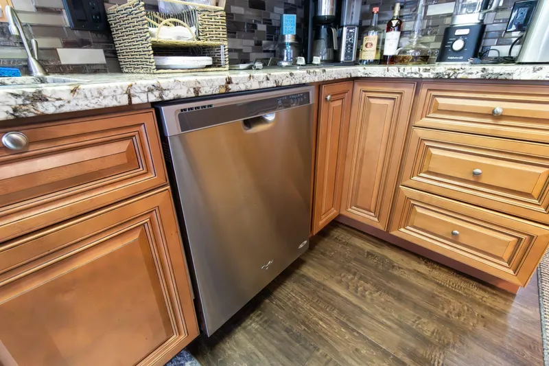 Slide: The Image of Luxury kitchen in 2001 Stardust Cruisers Executive Aft Cabin with stainless steel dishwasher. - 16