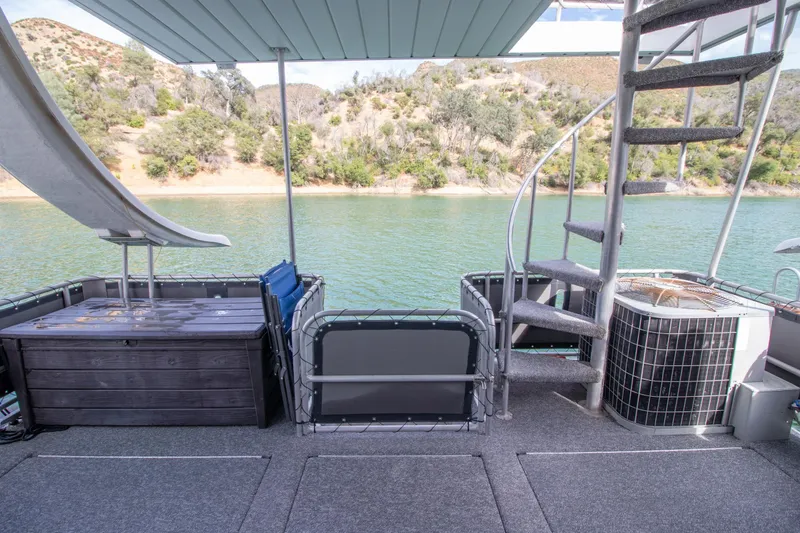 Slide: The Image of 2001 Stardust Cruisers Executive Aft Cabin with spiral staircase and waterslide on a serene lake. - 47