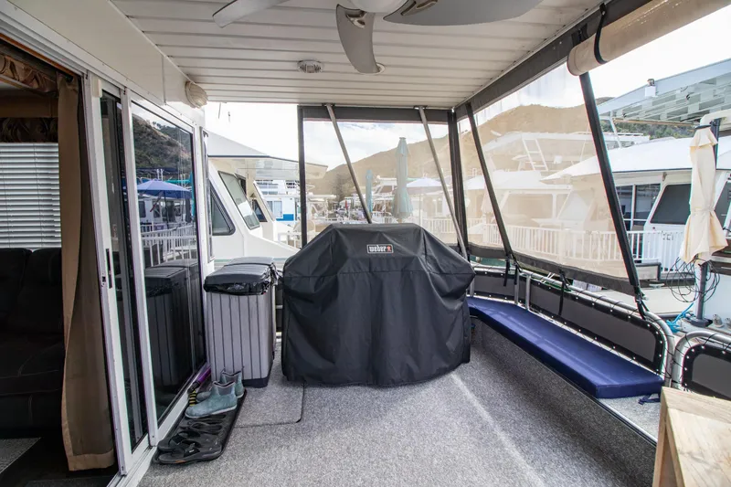 Slide: The Image of Covered deck area of 2001 Stardust Cruisers Executive Aft Cabin with grill and seating. - 6