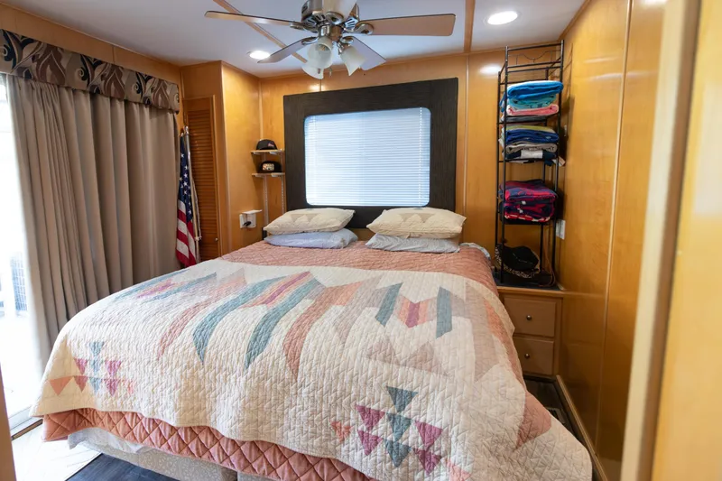 Slide: The Image of Cozy bedroom in 2001 Stardust Cruisers Executive Aft Cabin with quilted bedspread and American flag. - 43
