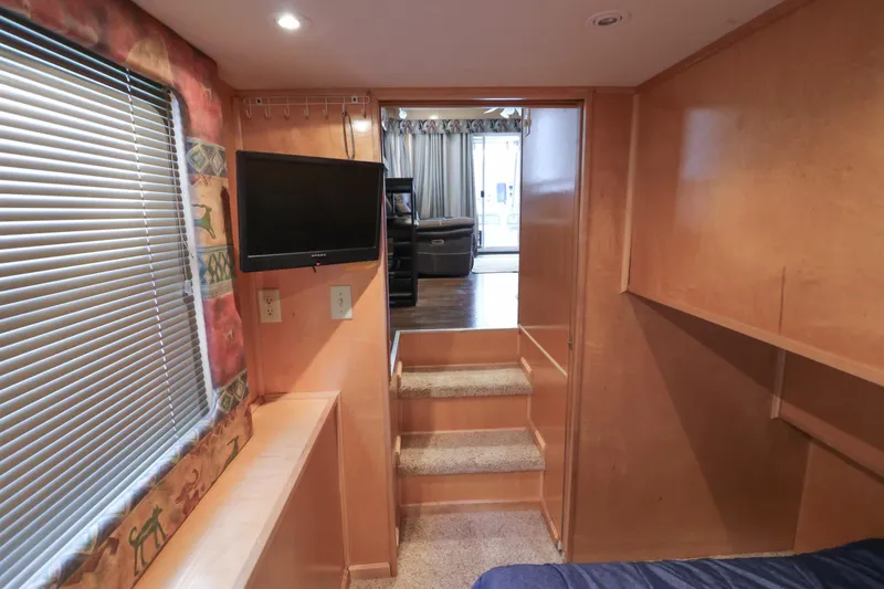 Slide: The Image of Interior of 2001 Stardust Cruisers Executive Aft Cabin with TV and stairs. - 22