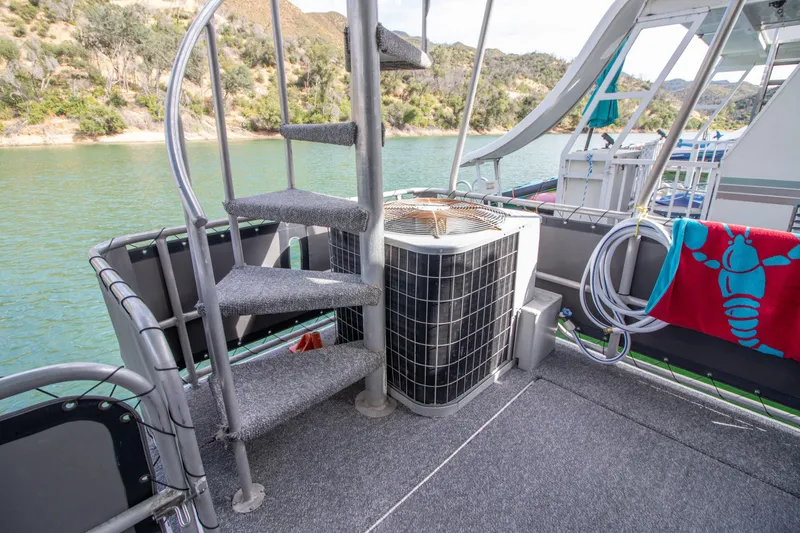 Slide: The Image of 2001 Stardust Cruisers Executive Aft Cabin deck with spiral staircase and scenic water view. - 49