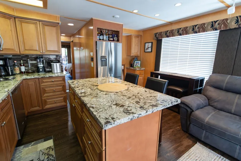 Slide: The Image of Luxurious kitchen interior of 2001 Stardust Cruisers Executive Aft Cabin with granite countertops. - 9