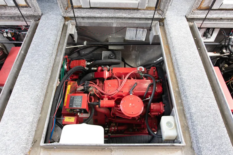 Slide: The Image of Engine compartment of 2001 Stardust Cruisers Executive Aft Cabin, featuring a red engine. - 53