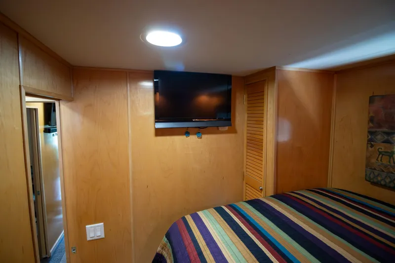 Slide: The Image of 2001 Stardust Cruisers Executive Aft Cabin bedroom with TV and colorful bedding. - 28