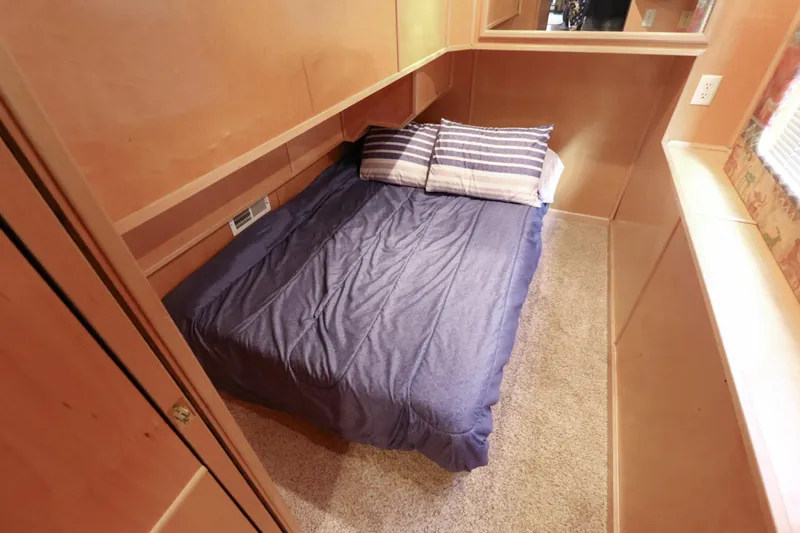 Slide: The Image of Cozy bedroom in 2001 Stardust Cruisers Executive Aft Cabin with blue bedding and striped pillows. - 20