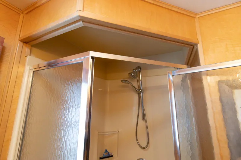 Slide: The Image of Shower area in 2001 Stardust Cruisers Executive Aft Cabin with glass door and chrome fixtures. - 31