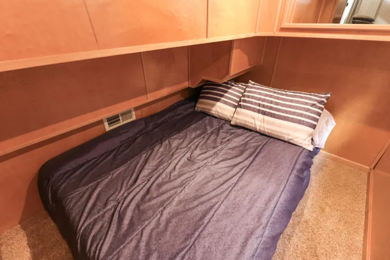 Slide: The Image of Cozy cabin bedroom in 2001 Stardust Cruisers Executive Aft Cabin with striped pillows. - 21