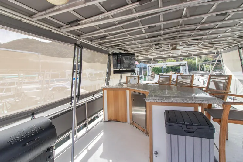 Slide: The Image of Outdoor seating area on 2001 Stardust Cruisers Executive Aft Cabin with grill and bar. - 60