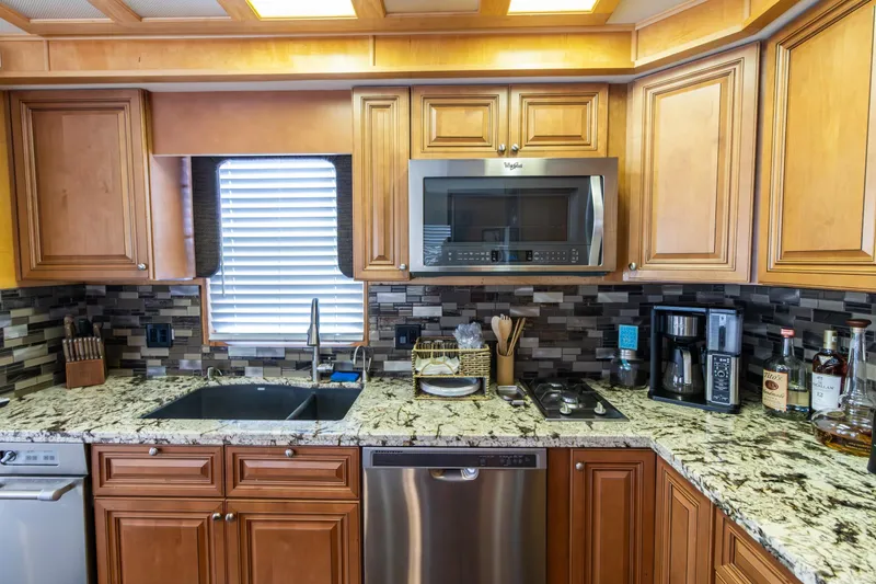 Slide: The Image of Luxurious kitchen in 2001 Stardust Cruisers Executive Aft Cabin with granite countertops. - 12