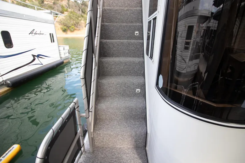 Slide: The Image of Stardust Cruisers 2001 Executive Aft Cabin boat stairs by water. - 65