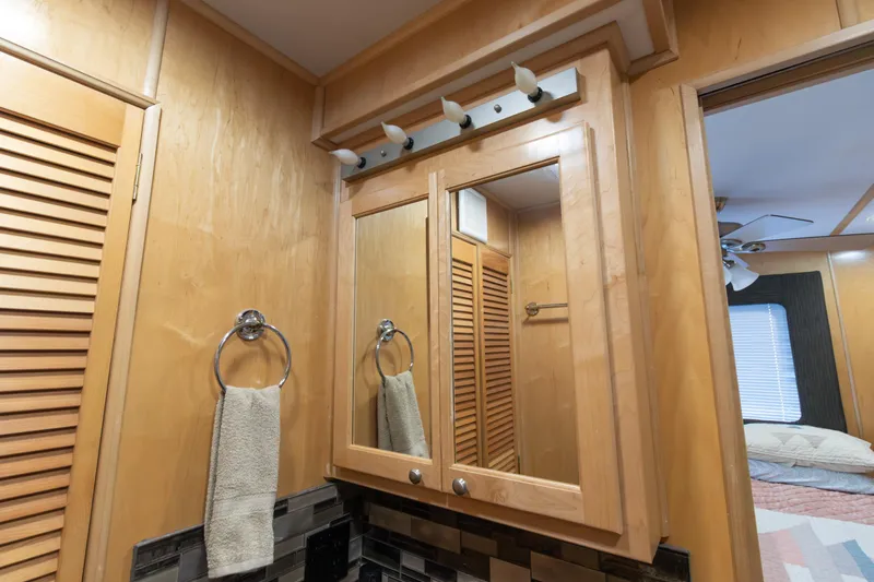 Slide: The Image of Bathroom interior of 2001 Stardust Cruisers Executive Aft Cabin with wooden cabinetry and mirror. - 41