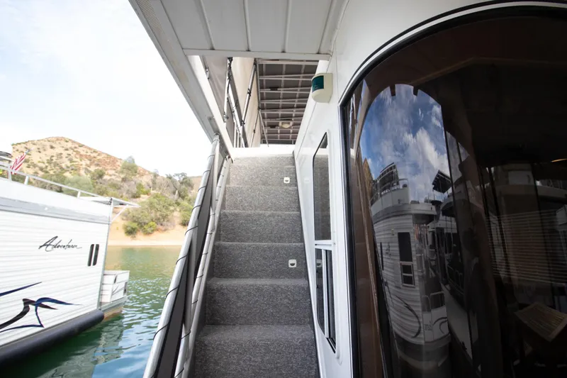 Slide: The Image of Stardust Cruisers 2001 Executive Aft Cabin with exterior stairs and scenic lake view. - 66