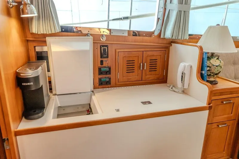Slide: The Image of Interior of 2012 Dettling Motoryacht with kitchenette, Keurig coffee maker, and wooden cabinetry. - 30