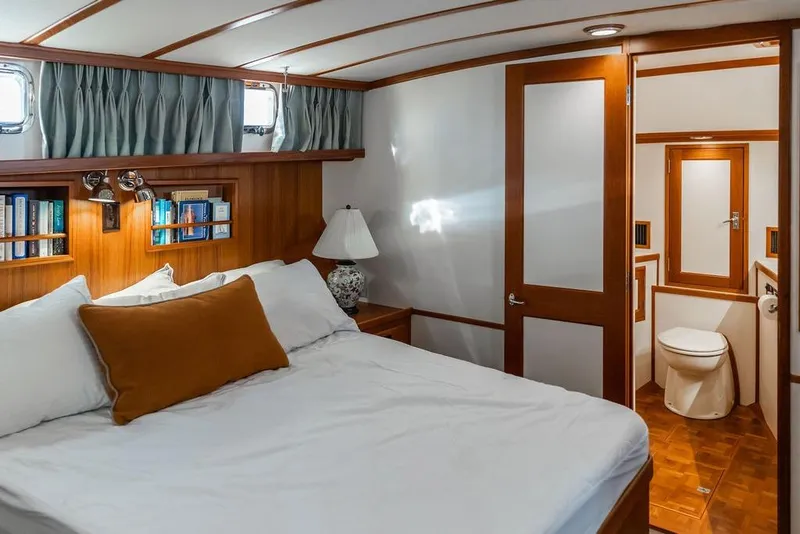 Slide: The Image of Luxurious 2012 Dettling Motoryacht bedroom with ensuite bathroom, featuring elegant wood finishes. - 33
