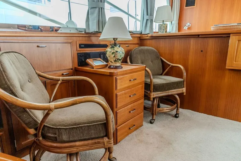Slide: The Image of Interior of 2012 Dettling Motoryacht with wooden furniture and cushioned chairs. - 23