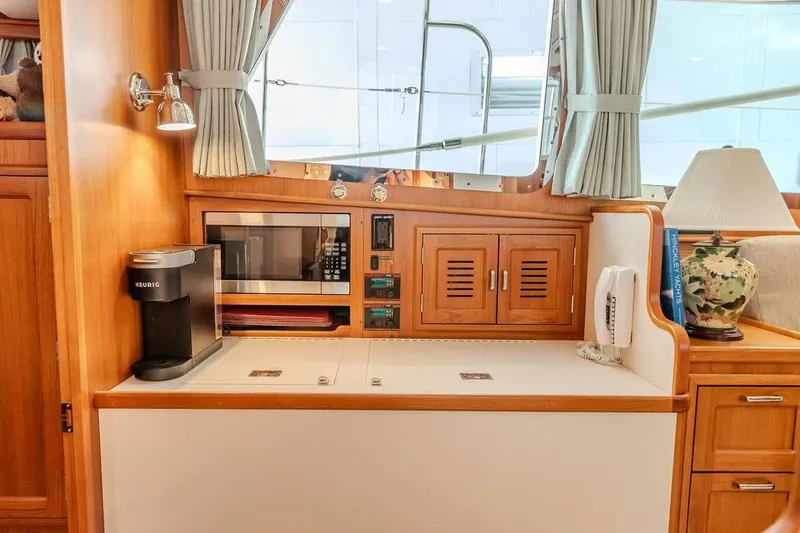 Slide: The Image of Interior of 2012 Dettling Motoryacht with microwave, coffee maker, and elegant wood cabinetry. - 29