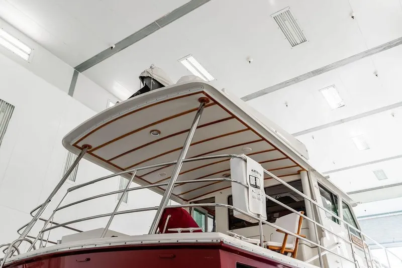 Slide: The Image of 2012 Dettling Motoryacht in indoor storage, showcasing upper deck and railing. - 12