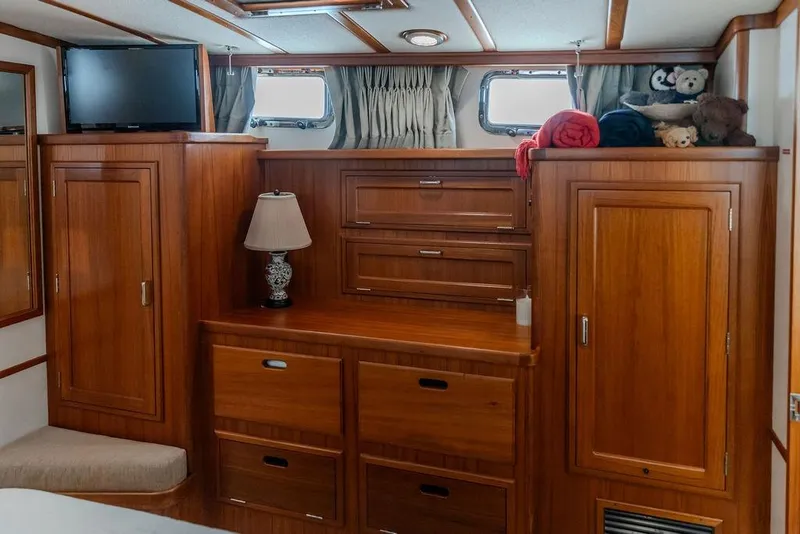 Slide: The Image of Luxurious 2012 Dettling Motoryacht interior with wooden cabinetry, TV, and cozy decor. - 35