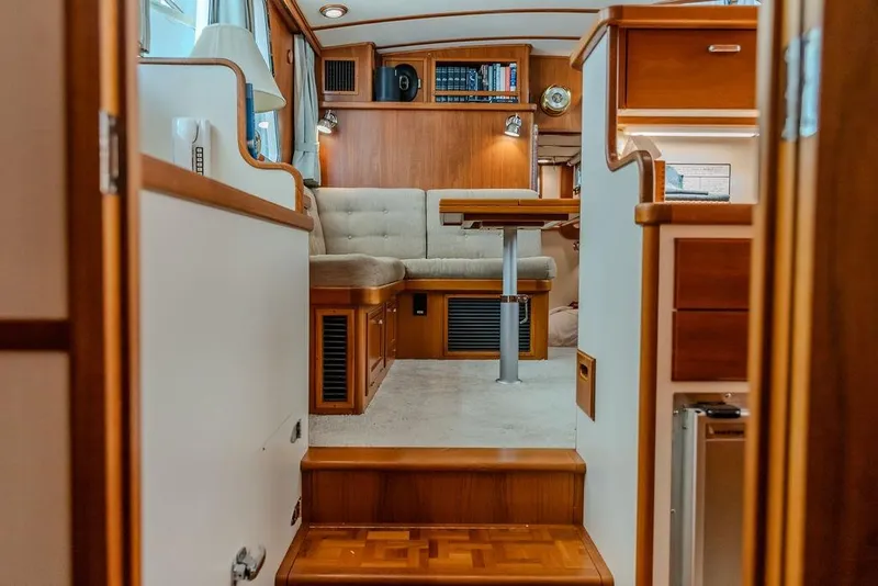 Slide: The Image of Interior of a 2012 Dettling Motoryacht featuring elegant wood finishes and cozy seating area. - 32