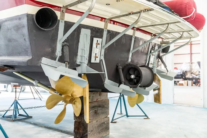 Slide: The Image of Rear view of 2012 Dettling Motoryacht showing propellers and rudders in a maintenance setting. - 43