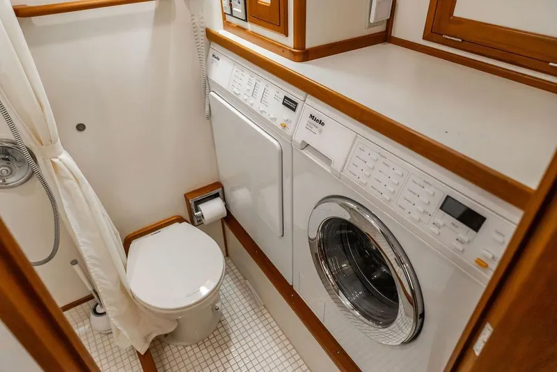 Slide: The Image of Laundry and bathroom area on a 2012 Dettling Motoryacht, featuring a Miele washer. - 40
