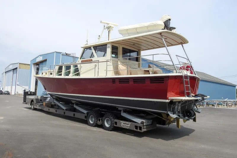 Slide: The Image of 2012 Dettling Motoryacht on trailer, red hull, dockside setting. - 5