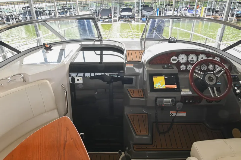 Slide: The Image of Interior view of 2009 Regal 3060 Window Express boat cockpit with steering wheel and navigation system. - 24