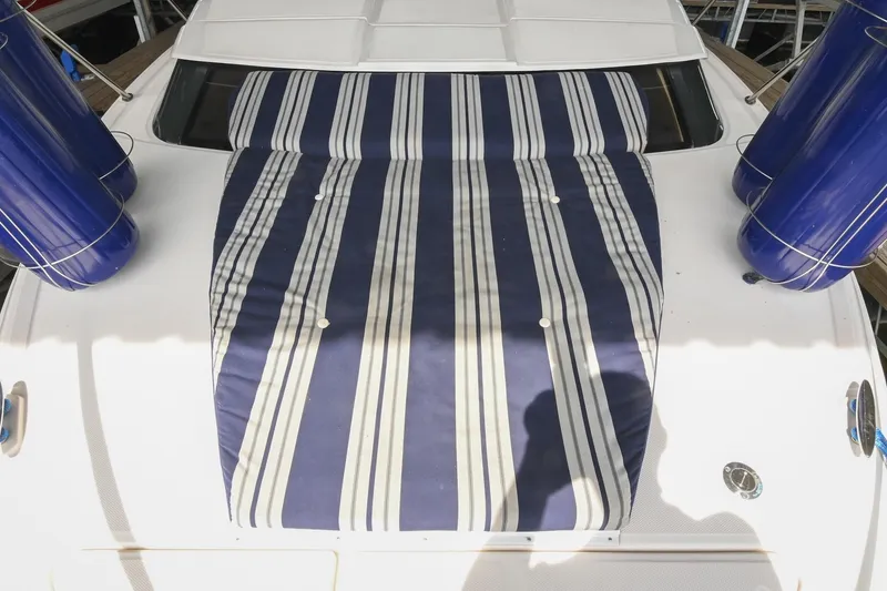 Slide: The Image of 2009 Regal 3060 Window Express boat with striped deck cushion and blue fenders. - 27