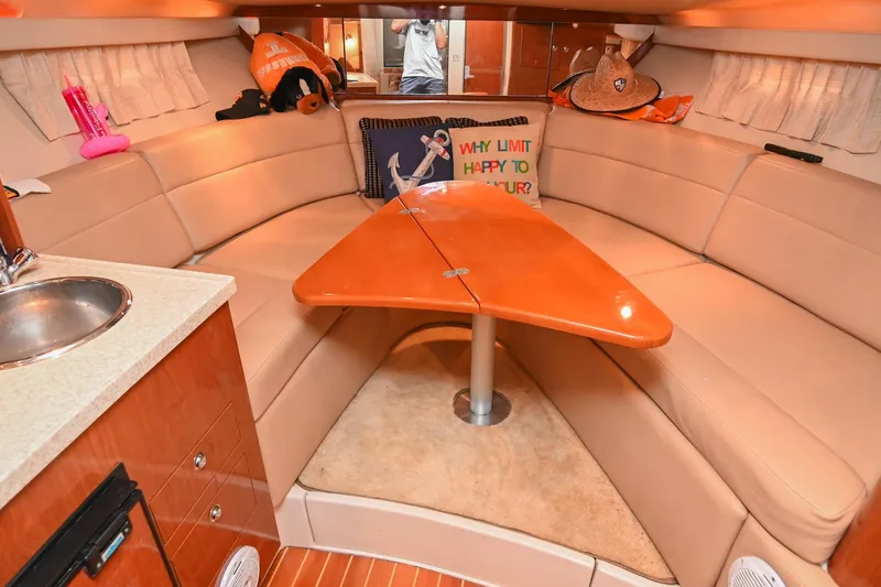 Slide: The Image of 2009 Regal 3060 Window Express cabin interior with cozy seating and wooden table. - 37