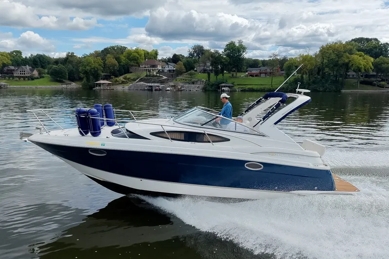 Slide: The Image of 2009 Regal 3060 Window Express cruising on a scenic lake with lush greenery. - 65