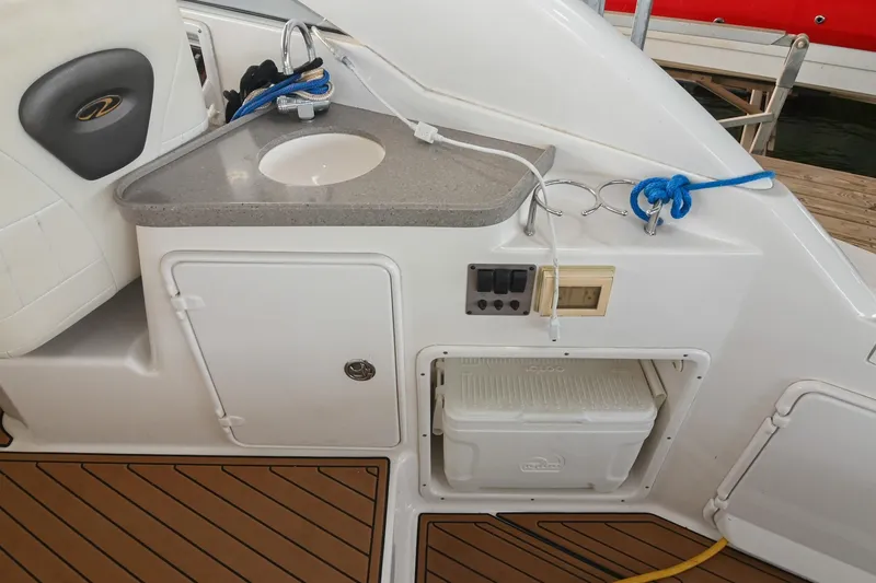 Slide: The Image of 2009 Regal 3060 Window Express boat interior with sink and storage compartment. - 13