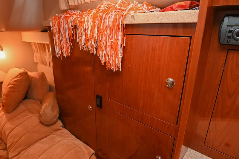 Slide: The Image of Interior of 2009 Regal 3060 Window Express with wooden cabinets and cozy seating area. - 44