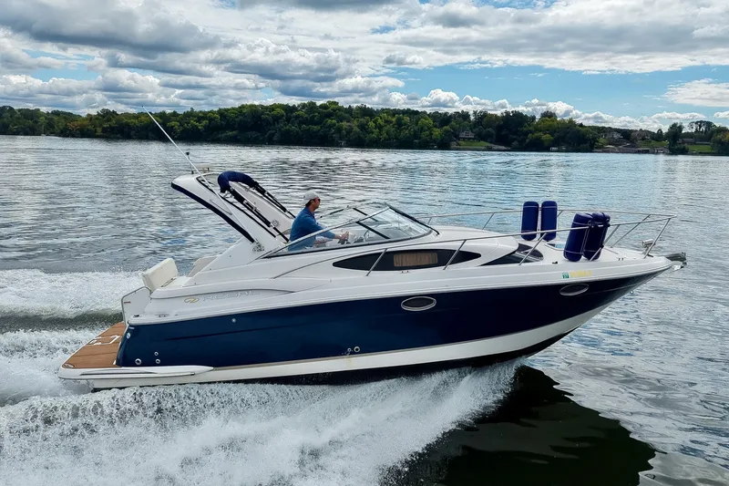 Slide: The Image of 2009 Regal 3060 Window Express cruising on a lake under a partly cloudy sky. - 64