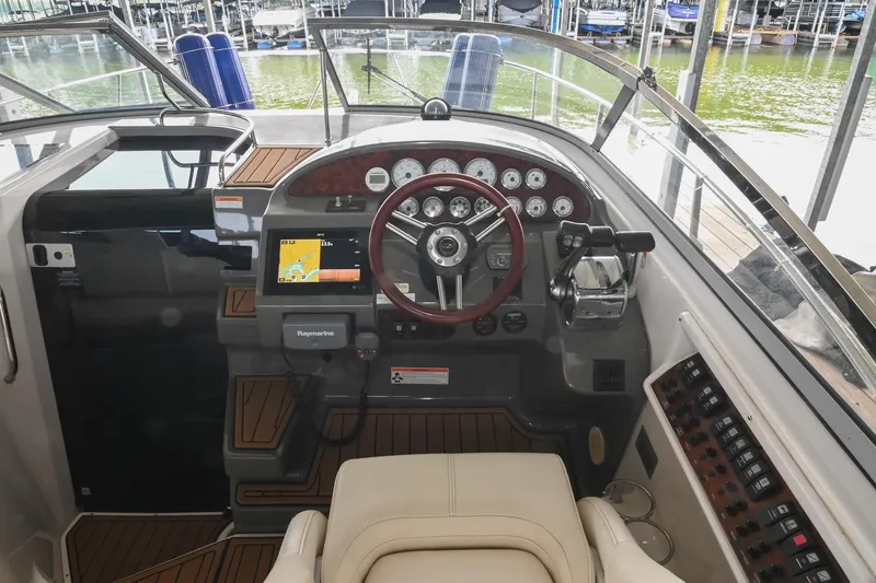 Slide: The Image of 2009 Regal 3060 Window Express boat cockpit with steering wheel and navigation system. - 19