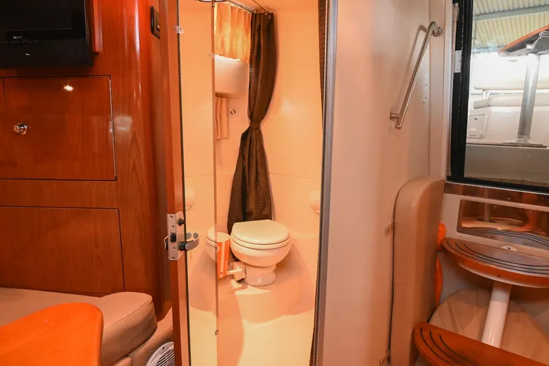 Slide: The Image of Interior of 2009 Regal 3060 Window Express boat featuring a compact bathroom. - 42