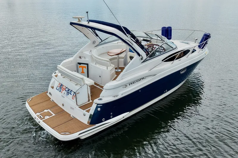 Slide: The Image of 2009 Regal 3060 Window Express boat on water, featuring sleek design and spacious deck. - 8