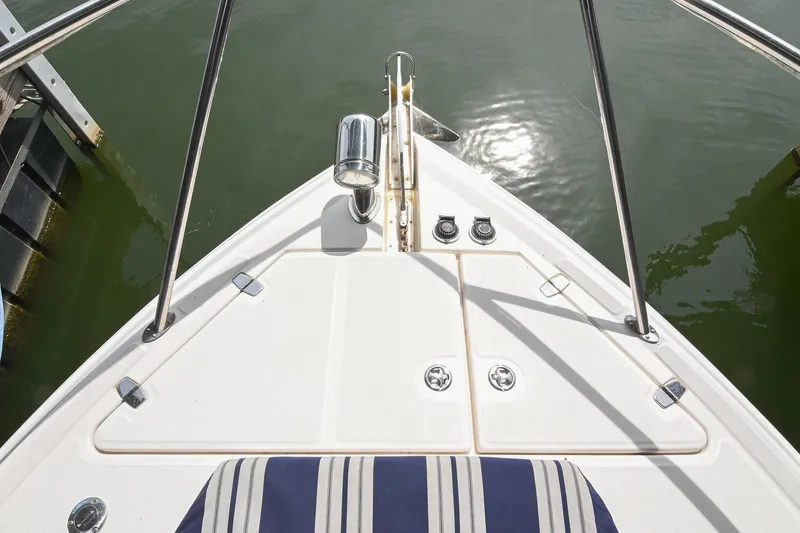 Slide: The Image of Bow view of 2009 Regal 3060 Window Express boat docked on water. - 28