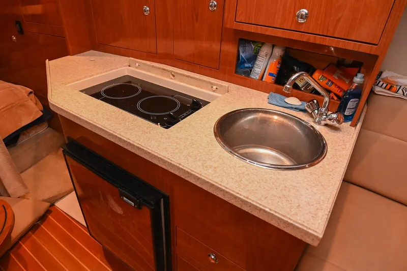 Slide: The Image of 2009 Regal 3060 Window Express yacht kitchenette with sink and stove. - 34