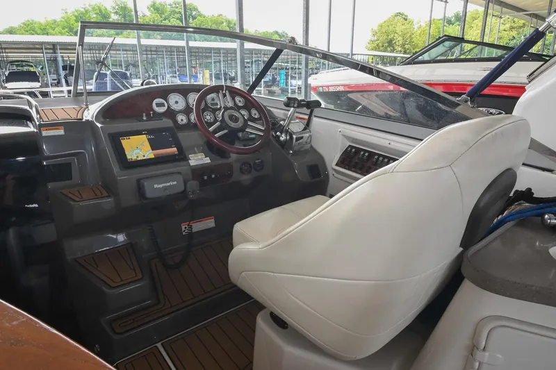 Slide: The Image of 2009 Regal 3060 Window Express boat cockpit with steering wheel and navigation system. - 18