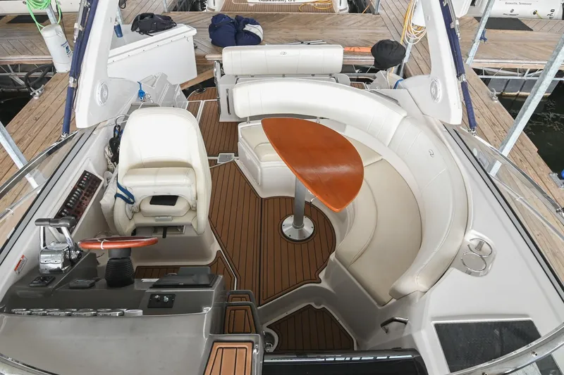 Slide: The Image of 2009 Regal 3060 Window Express boat interior with seating and wooden table. - 8