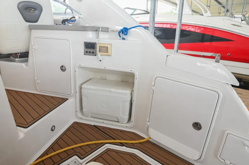 Slide: The Image of 2009 Regal 3060 Window Express boat interior with storage compartments and cooler. - 12