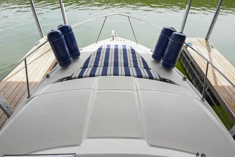 Slide: The Image of 2009 Regal 3060 Window Express boat with striped sunbed and docked fenders. - 25