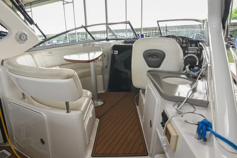 Slide: The Image of Interior of a 2009 Regal 3060 Window Express boat with seating and helm. - 14