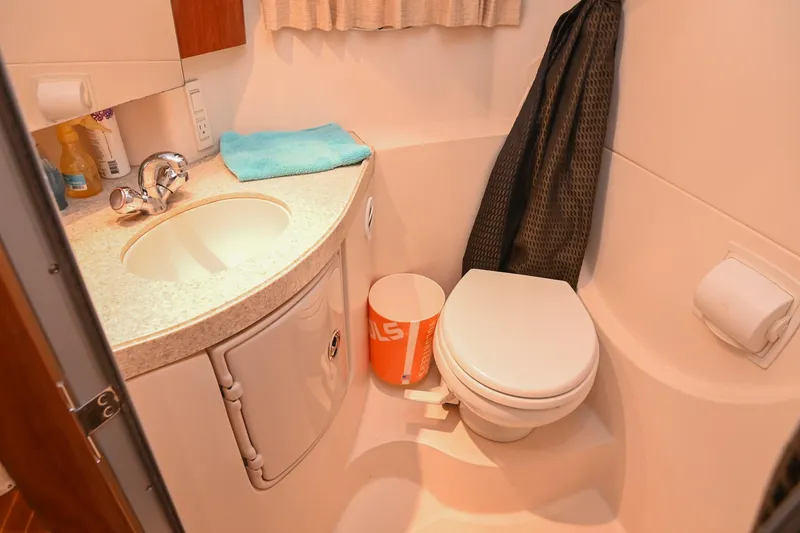 Slide: The Image of Compact bathroom in 2009 Regal 3060 Window Express boat, featuring sink and toilet. - 43