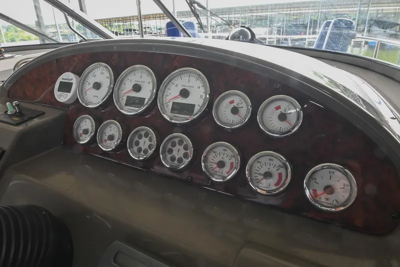 Slide: The Image of Dashboard of a 2009 Regal 3060 Window Express boat with multiple gauges and controls. - 22