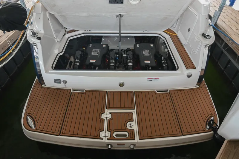 Slide: The Image of 2009 Regal 3060 Window Express boat engine compartment with open hatch and teak deck. - 47
